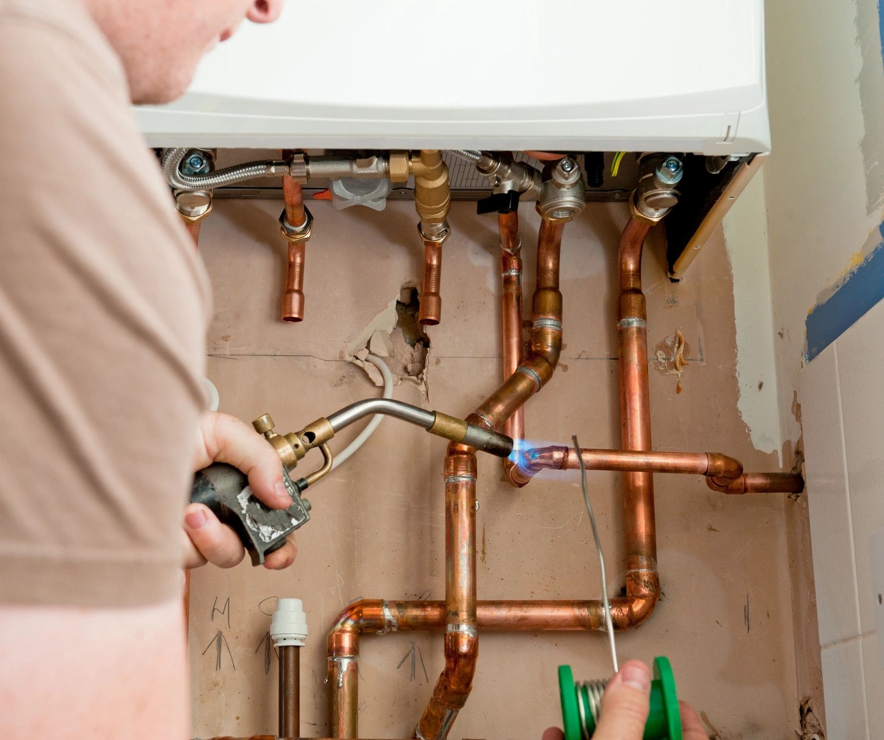 Essential Plumbing technician repairing pipes in Butts County, GA